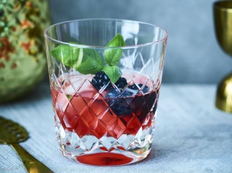 Cocktail van whisky, blauwe bessen en basilicum